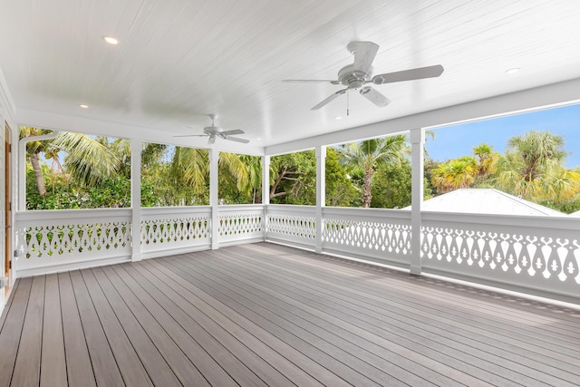 unfurnished sunroom with a ceiling fan