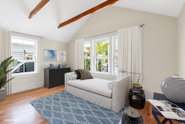 bedroom featuring vaulted ceiling with beams, wood finished floors, and baseboards