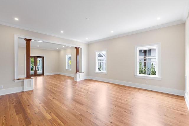 unfurnished living room featuring light wood finished floors, recessed lighting, decorative columns, and baseboards