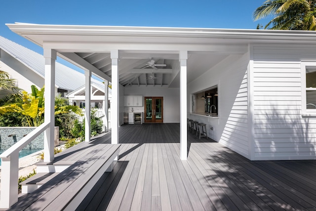 deck featuring french doors, a sink, and a ceiling fan