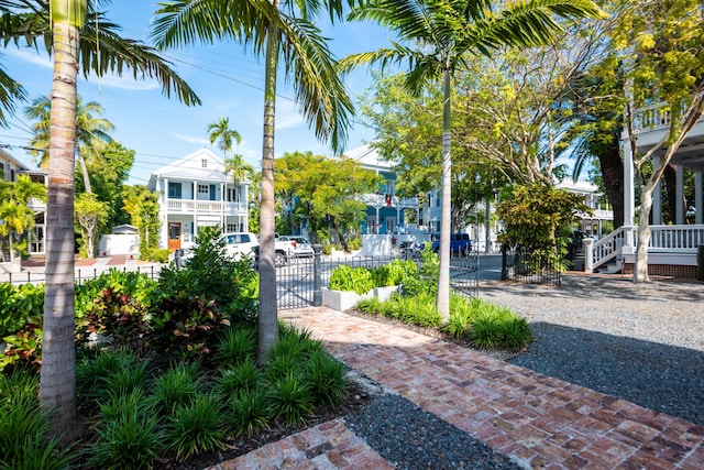 view of property's community featuring fence and a gate