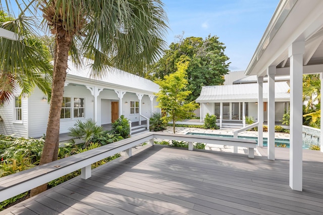 wooden deck featuring an outdoor pool