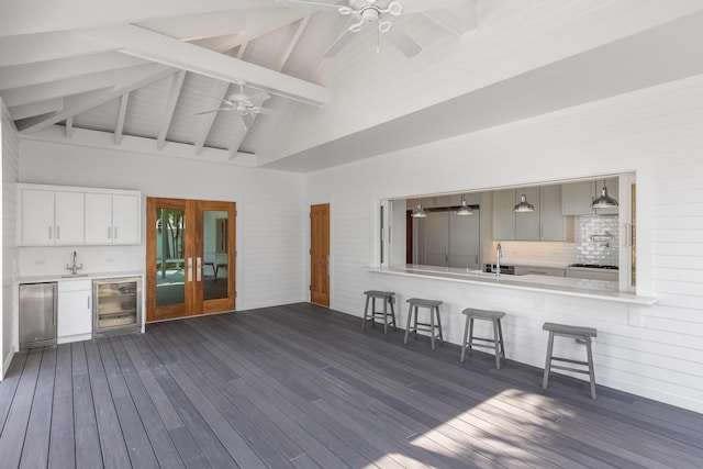 interior space featuring ceiling fan, beverage cooler, outdoor dry bar, and a sink