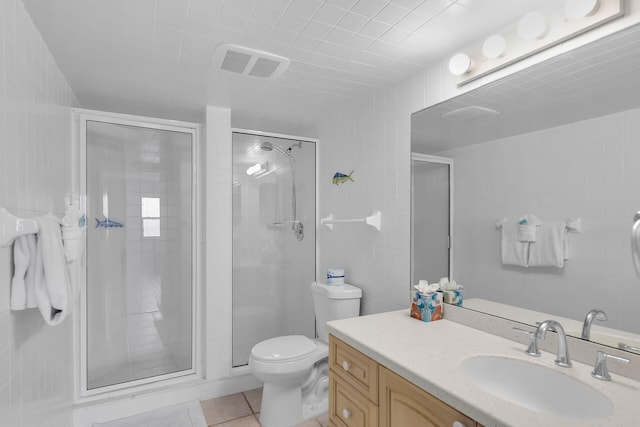 bathroom featuring a stall shower, visible vents, toilet, tile patterned floors, and vanity