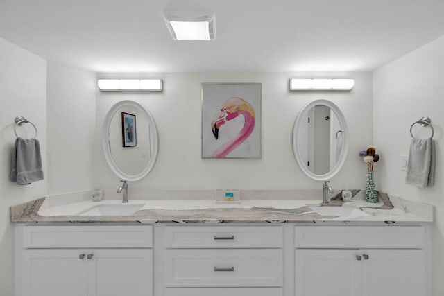 full bathroom featuring double vanity and a sink