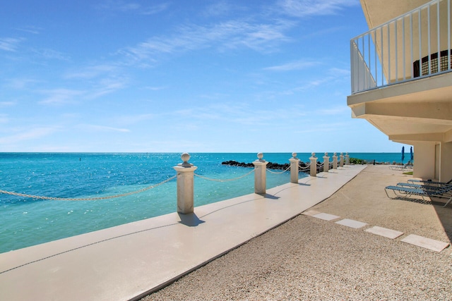 view of swimming pool featuring a water view