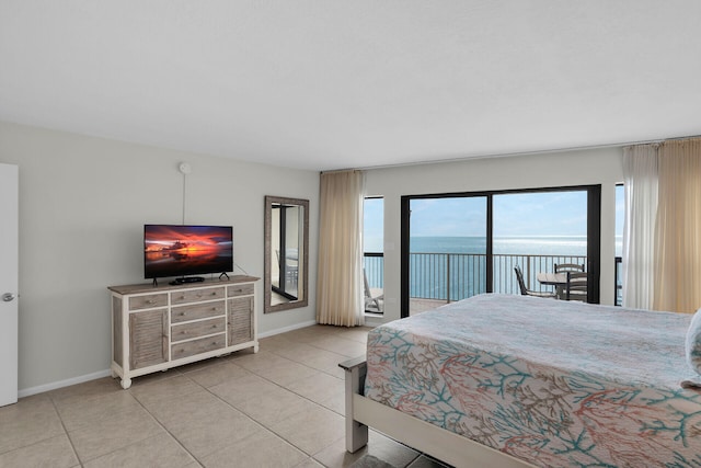 tiled bedroom with access to outside and baseboards