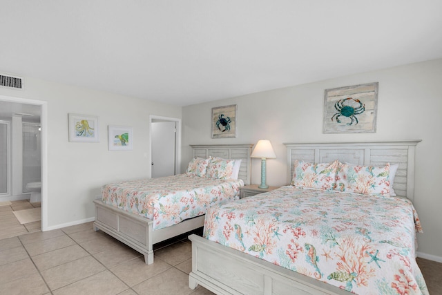 bedroom with light tile patterned floors, baseboards, visible vents, and connected bathroom