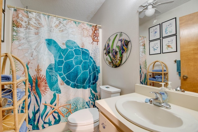 full bath featuring a shower with shower curtain, toilet, ceiling fan, a textured ceiling, and vanity