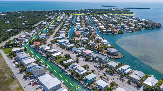 drone / aerial view featuring a residential view and a water view