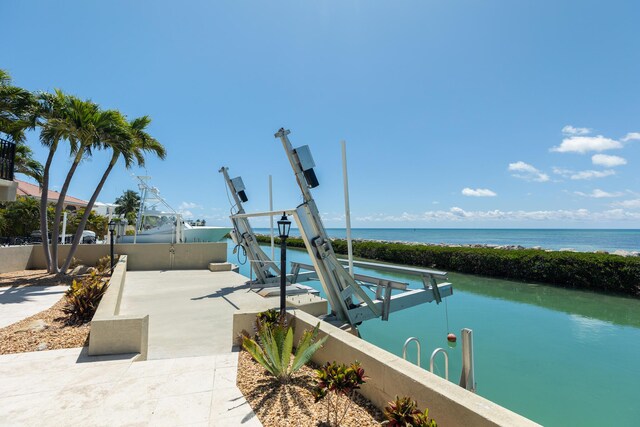 view of pool featuring a boat dock, a water view, and boat lift