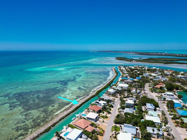 birds eye view of property with a beach view and a water view