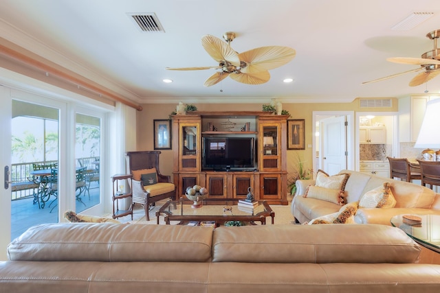 living room featuring crown molding, a ceiling fan, and visible vents