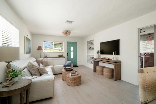 125 Harbor Dr, Key Largo, FL 33037 - living area featuring built in shelves and wood finished floors