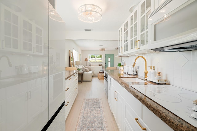 125 Harbor Dr, Key Largo, FL 33037 - kitchen featuring white appliances, stone countertops, backsplash, glass insert cabinets, and open floor plan