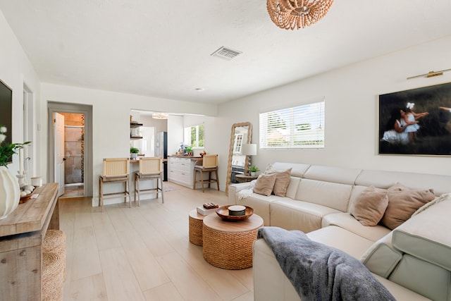 125 Harbor Dr, Key Largo, FL 33037 - living room with light wood finished floors and a chandelier