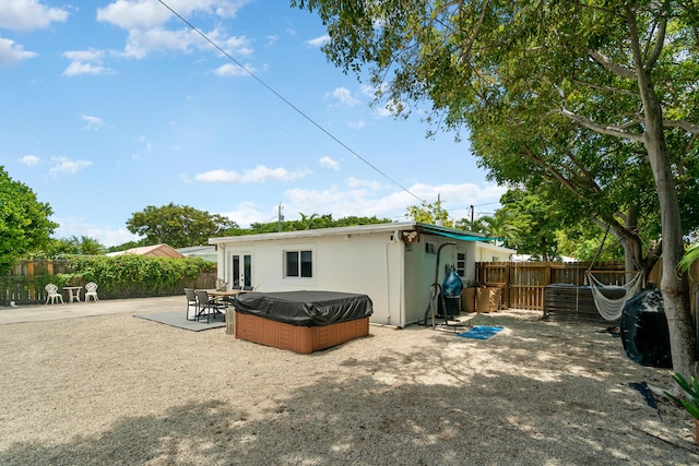 125 Harbor Dr, Key Largo, FL 33037 - back of property featuring a hot tub and a patio area