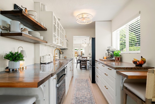 125 Harbor Dr, Key Largo, FL 33037 - kitchen with oven, butcher block countertops, plenty of natural light, and freestanding refrigerator
