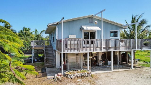 back of house with driveway, stairway, a patio, and a wooden deck