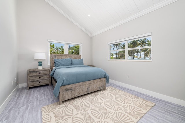 bedroom with baseboards, multiple windows, and wood finished floors
