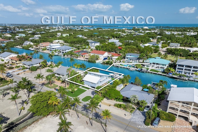 drone / aerial view featuring a residential view and a water view