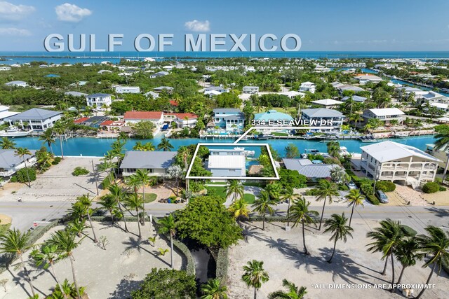 bird's eye view featuring a water view and a residential view