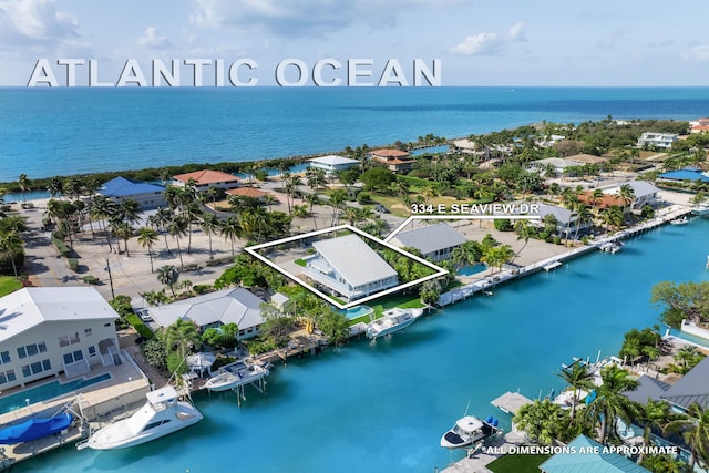 drone / aerial view with a water view and a residential view