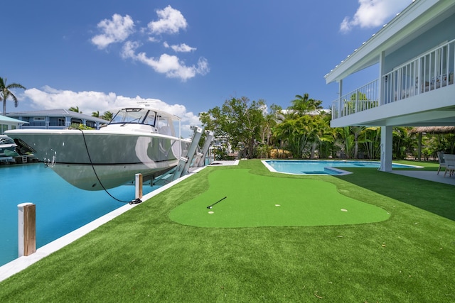 surrounding community featuring a swimming pool, a dock, and boat lift