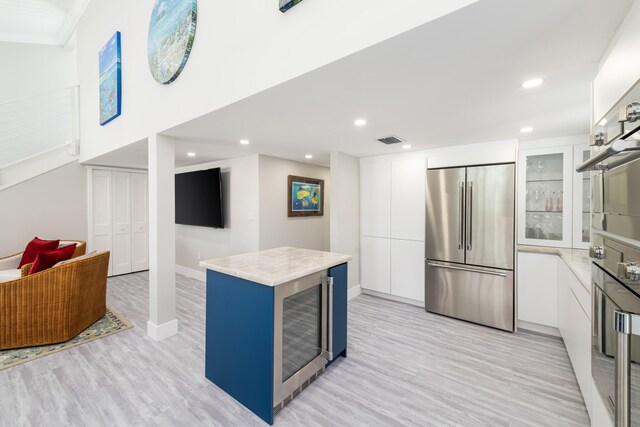 kitchen featuring appliances with stainless steel finishes, modern cabinets, and white cabinetry