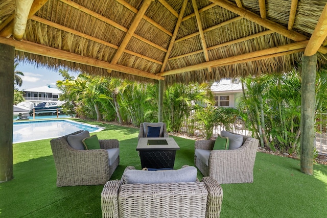 view of patio with a gazebo, an outdoor pool, and a fire pit