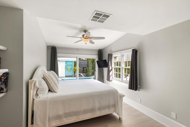 bedroom with ceiling fan, lofted ceiling, and light hardwood / wood-style floors