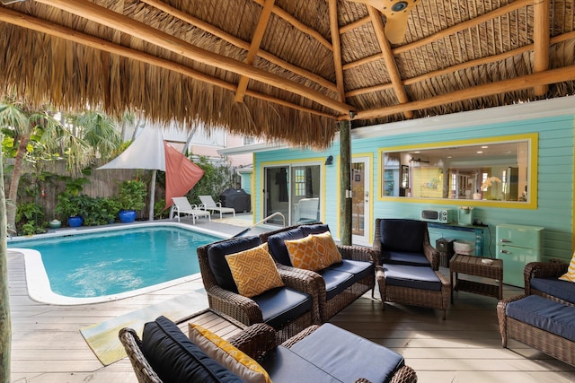 view of pool with a gazebo, outdoor lounge area, and a deck