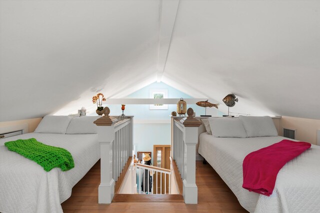 bedroom featuring vaulted ceiling and dark hardwood / wood-style floors