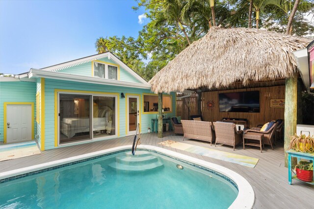 view of swimming pool with a wooden deck and an outdoor hangout area