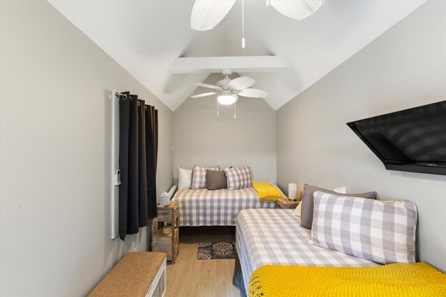 bedroom featuring vaulted ceiling with beams and light wood-type flooring