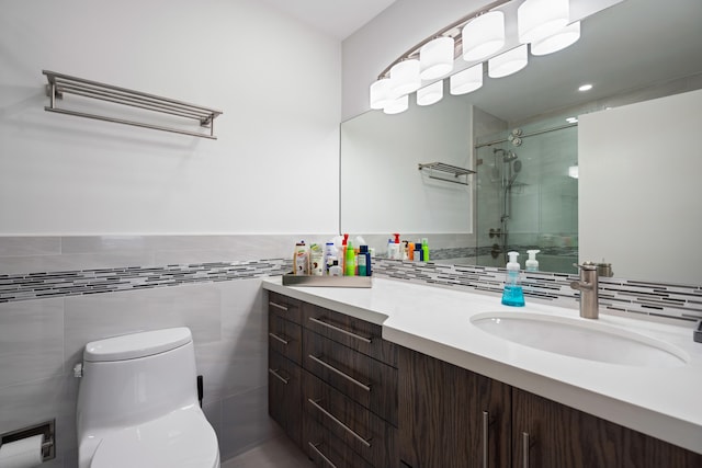 bathroom with vanity, toilet, an enclosed shower, and tile walls