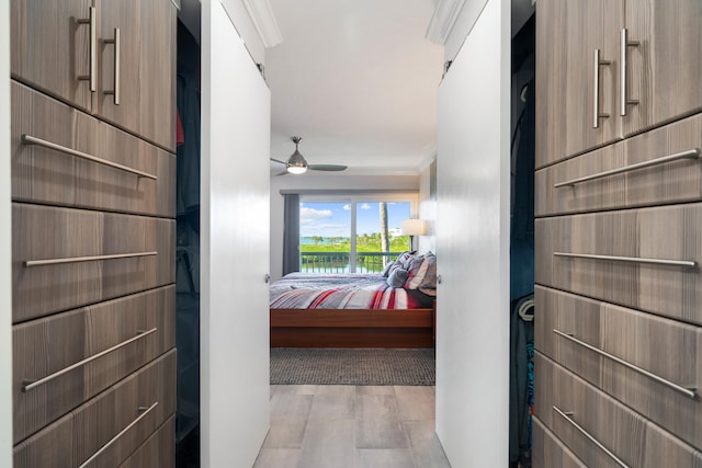 corridor with crown molding and light hardwood / wood-style floors