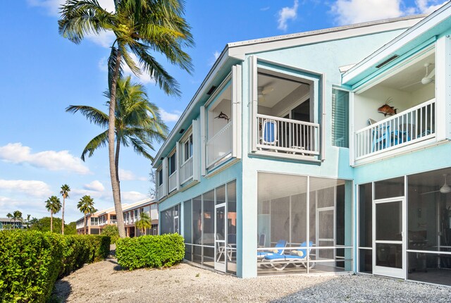 rear view of property featuring a sunroom