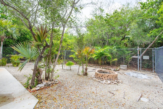 28212 Gato Rd, Little Torch, FL 33042 - view of yard with an outdoor fire pit and a gate
