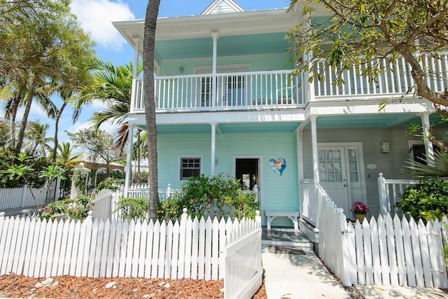 view of front of house with a porch and a balcony