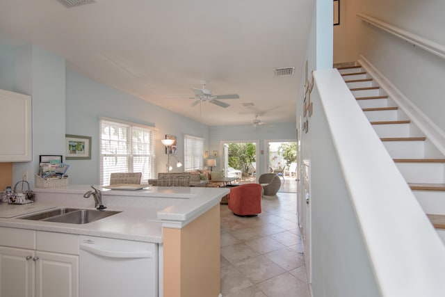 kitchen featuring white cabinetry, sink, light tile patterned floors, and dishwasher