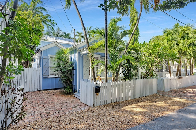 820 Carsten Ln, Key West, FL 33040 - view of home's exterior featuring board and batten siding and a gate
