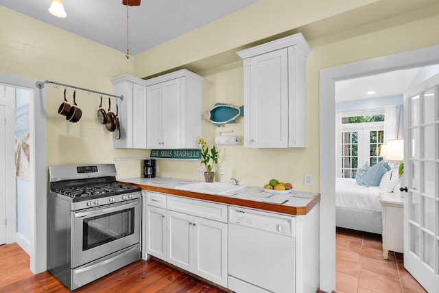 820 Carsten Ln, Key West, FL 33040 - kitchen with stainless steel range with gas cooktop, dishwasher, and white cabinetry