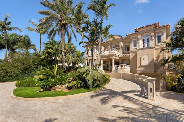 69 Cannon Royal Dr, Shark Key, FL 33040 - mediterranean / spanish-style home with stucco siding, driveway, cooling unit, a balcony, and a tiled roof