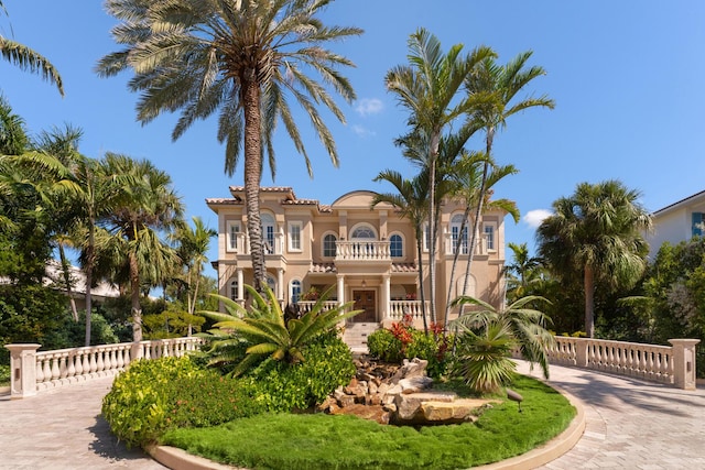 69 Cannon Royal Dr, Shark Key, FL 33040 - mediterranean / spanish home with a balcony, curved driveway, and stucco siding
