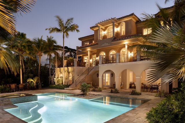 69 Cannon Royal Dr, Shark Key, FL 33040 - rear view of property with a patio, a balcony, a tile roof, and stucco siding