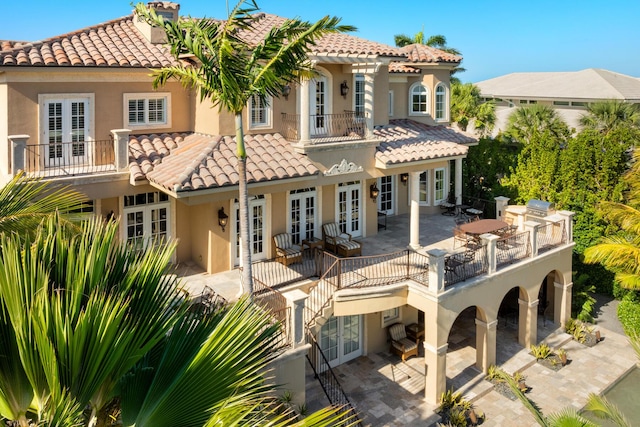 69 Cannon Royal Dr, Shark Key, FL 33040 - back of house featuring french doors, stucco siding, and a tiled roof
