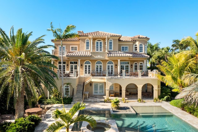 69 Cannon Royal Dr, Shark Key, FL 33040 - back of house featuring french doors, a patio area, stairway, and stucco siding