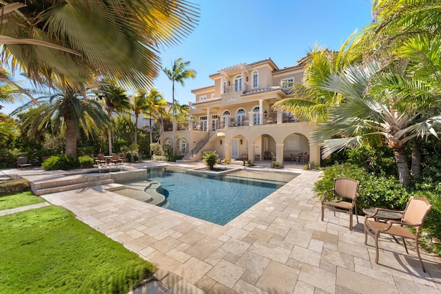 69 Cannon Royal Dr, Shark Key, FL 33040 - view of swimming pool with a pool with connected hot tub, stairs, and a patio area