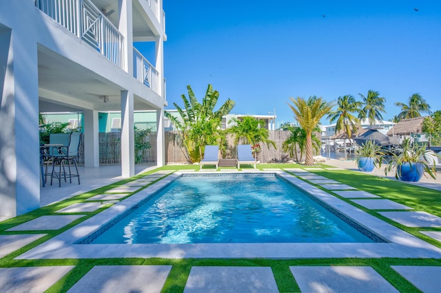 view of swimming pool featuring a patio area, a fenced backyard, and a fenced in pool